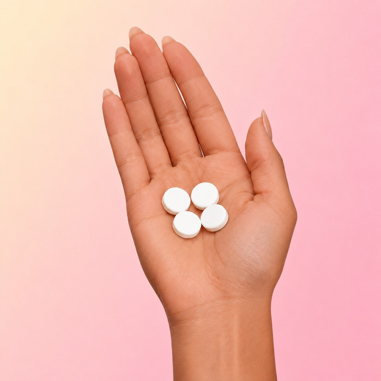 Four Aphia creatine chews in the palm of a hand