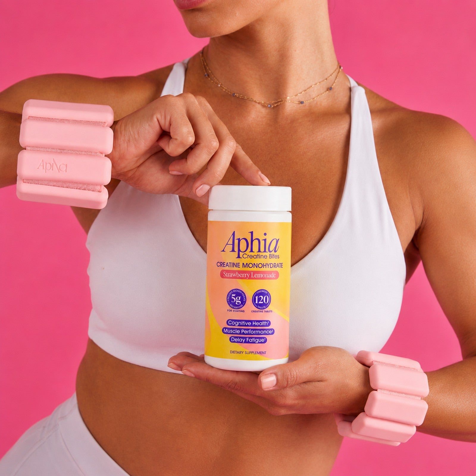 Woman in the gym enjoying an Aphia strawberry lemonade creatine chew